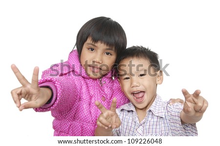 Happy portrait of a brother and sister posing hand gesture