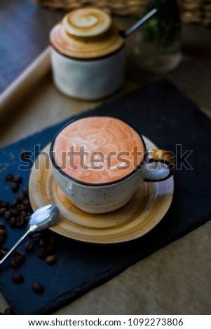 Coffee with orange syrup and sugar bowl on the table