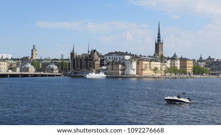 An amazing view of Stockholm from the tower of city hall. The city is surrounded by water. The boat complete this perfect picture. Sweden.