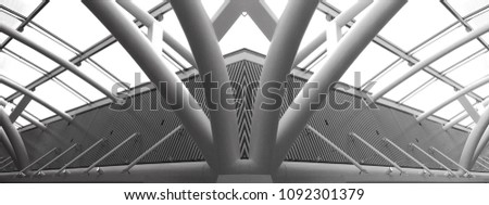 Collage photo of glass and metal structures resembling futuristic building. Abstract black and white modern architecture or construction industry panoramic photo with multiple steel pillars / girders.
