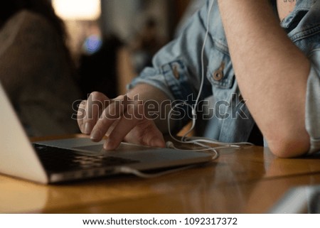 picture of hands, laptop, cellphone and a tablet