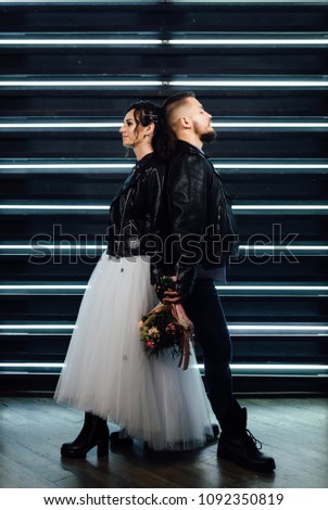 Wedding in the style of rock. Rocker or Biker wedding. Guys with stylish leather jackets. It's a rock'n'roll baby! Sweet couple in a photo studio. Steep shooting with mirrors and lamps.