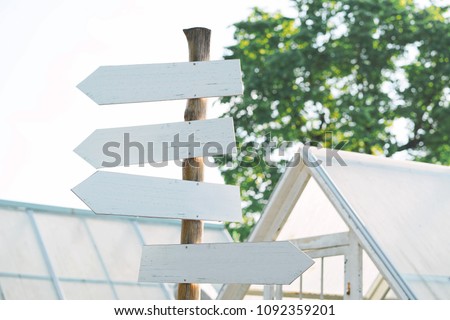 White blank wooden sign in a farm or garden.                      