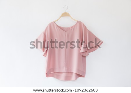Woman blouse with Pink blouse cotton on white background. Royalty-Free Stock Photo #1092362603