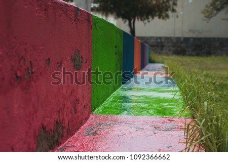 wet stone colorful bench in an outdoor park 