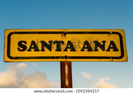 Santa Ana city street old antique yellow sign with blue sky at background, USA signal city series.