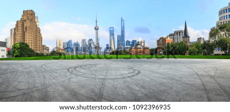 Empty asphalt square and modern city architecture in Shanghai at sunset