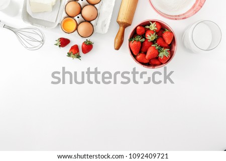 Recipe for strawberry pie. Raw ingredients for cooking strawberry pie or cake on white background with copy space (eggs, flour, milk, sugar, strawberry), top view, flat lay. Bakery background Royalty-Free Stock Photo #1092409721