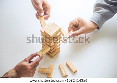 Alternative risk plan and strategy in business, Young intelligent business team playing the wood game, hands of executive cooperation placing wood block on the tower, Collaborative management. Royalty-Free Stock Photo #1092414356