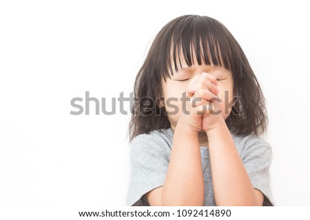 Portrait of little cute asian girl praying, young girl with her hands together isolated on white background, close up expression. Religion believe hope pray stressful concept