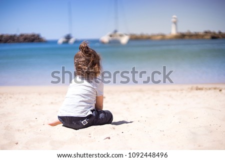 selective soft focus a hairy boy sitting on sand beach in summer