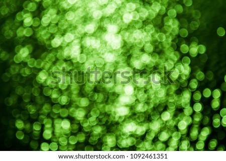 Abstract blur / defocused green background textures of bokeh of the lighting reflection with the water and change color in picture processing program. Abstract background concept