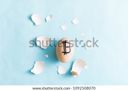 Egg with bitcoin on a blue background.