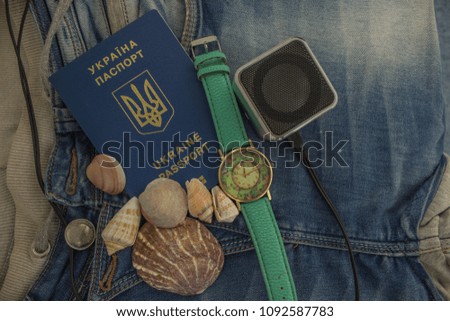 seashells with passport documents concept on jeans background texture