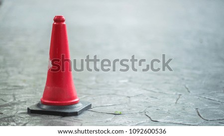 Traffic cone on road. Red traffic cone standing outside. Traffic cone at parking area