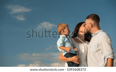 Happy Family are sweet kiss and hug on the beach While relaxing on weekends with blur sea background in travel and holiday concept