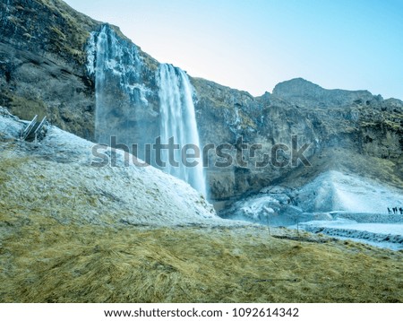 Seljalandsfoss waterfall, one of landmark in Iceland, large waterfall with natural cliff in winter season with snow and ice around