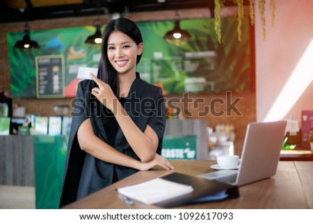 woman holding credit card on laptop for online shopping