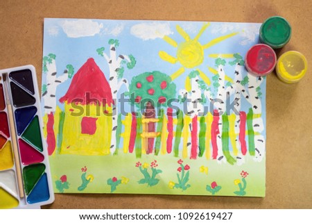 Bright childrens drawing with house, fence, trees, flowers with lying paints - concept of children creativity