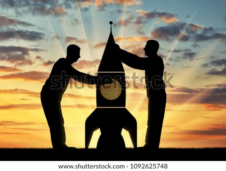 Silhouettes of two men picking up a rocket. The concept of mutual fund