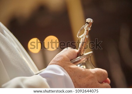 Asperges: liturgical object used by Catholic Christian priests to bless faithful believers by throwing holy water drops on them. Royalty-Free Stock Photo #1092644075