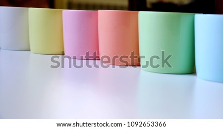 Colorful empty tea or coffee cups on white background.