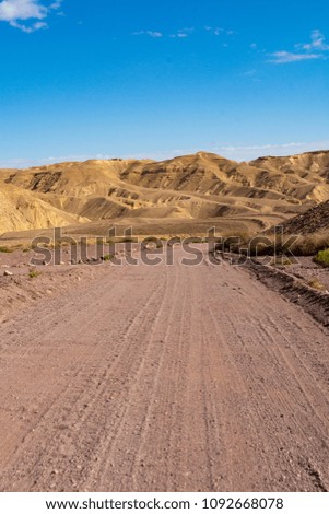 Dirt road in desert Negev, Israel,  transport infrastructure in desert, scenic mountains route from Eilat to north of Israel