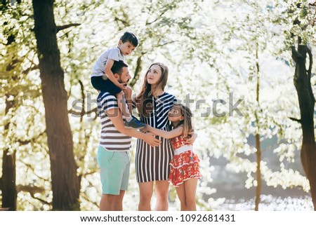 Happy family in the park.Pregnant mother with her family on vacation