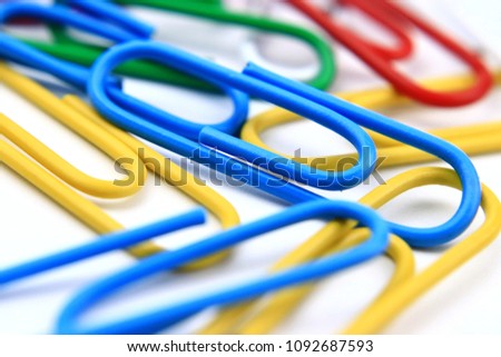 Colorful paperclip, collection of education office supplies, close up, macro on white background