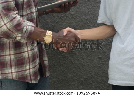 diffrent color handshake, black and yelow handshaking, white and black handshake