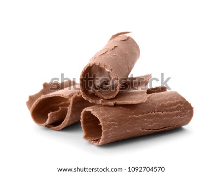 Delicious milk chocolate curls on white background
