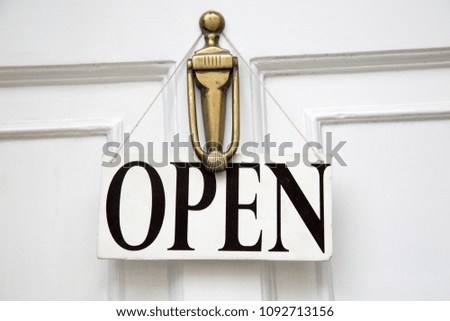 White Open Sign on Shop Door