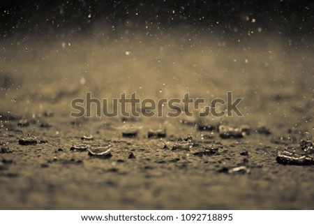 Heavy rain drops on the ground with  vintage color tone