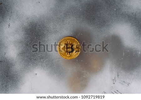 Modern silver foil  scratched abstract background with a gold bitcoin. Golden coin of e-currency symbol of new technologies.