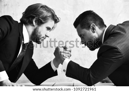 arm wrestling of businessman and compete man