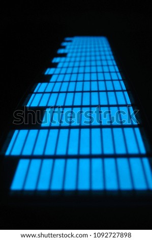 On a black background, a glowing hail, a display of blue rectangles