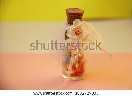Wedding favor with candies presented in a glass jar.
 Royalty-Free Stock Photo #1092729035