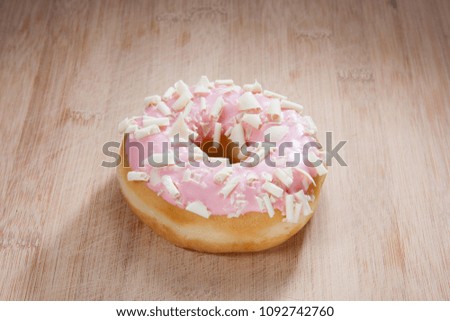 Single delicious donut on wood