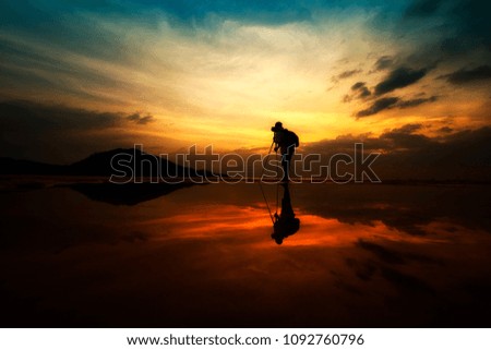 Landscape Photographer silhouette reflection on beach
