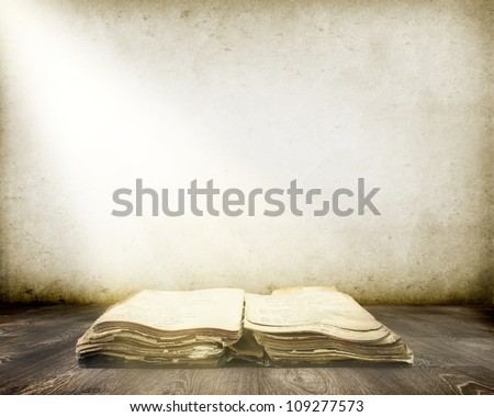 Old book on wood with Ray of light background