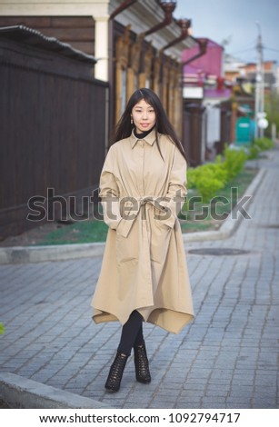 Asian student walking along the street
