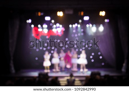 Texture blur scene multicolored lights and smoke in concert with silhouettes of people. Background for design, blur texture, actors on stage.