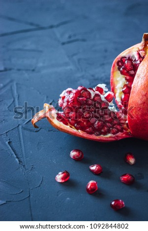 Fresh pomegranates on black background