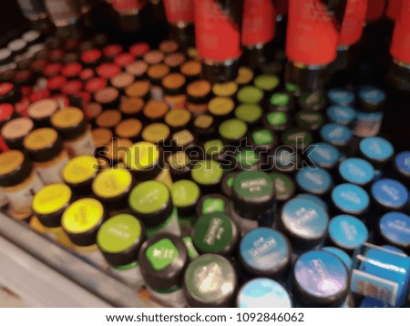 blur photo of various color acrylic paints in containers.