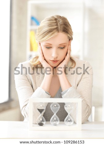 picture of pensive businesswoman with sand glass