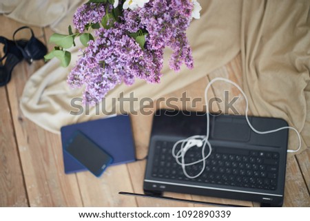 Female working place with laptop, planer, phone and flowers. Spring or business concept. Inspiration for work from home