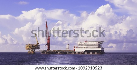 Side View of Tender Drilling Oil Rig (Barge Oil Rig) in The southeast asia sea.
Black&White.