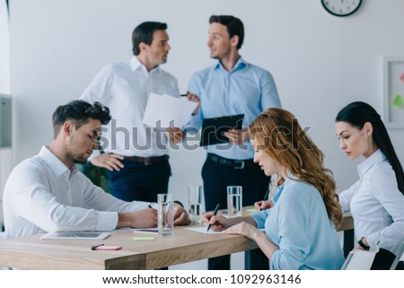 business coworkers with papers having business training in office