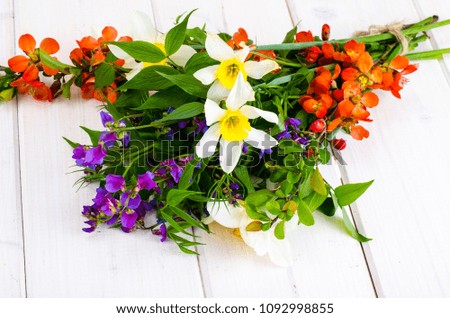 Bouquet of bright freshly cut flowers on wooden table. Studio Photo
