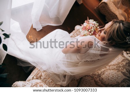 Portrait of a beautiful blonde bride with a bouquet. The bride morning.Wedding photo